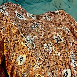 Brina &EM size XXL fits like an XL. Mainly orange with blue and white.